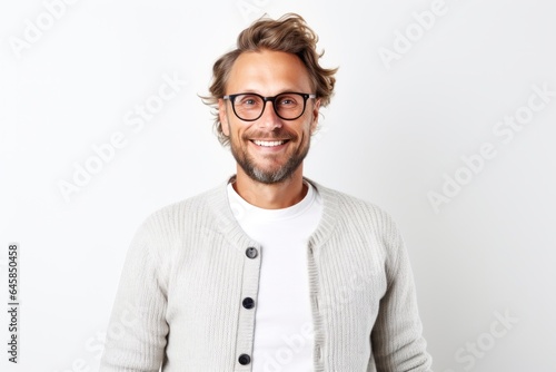 Portrait photography of a cheerful Swedish man in his 30s against a white background © Anne Schaum