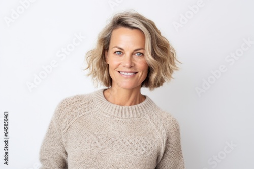 Portrait photography of a Swedish woman in her 40s wearing a cozy sweater against a white background