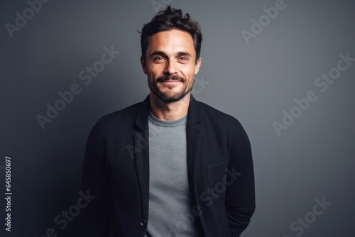 Medium shot portrait photography of a French man in his 30s against a minimalist or empty room background