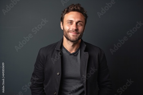 Medium shot portrait photography of a French man in his 30s against a minimalist or empty room background photo