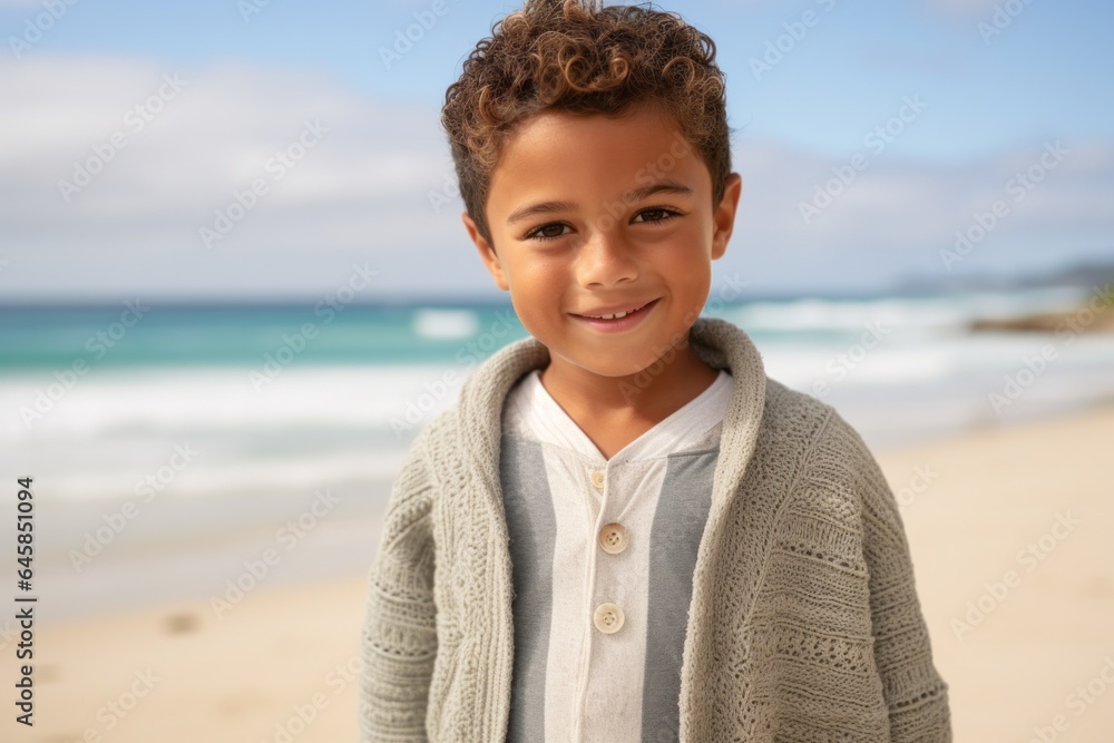 Portrait photography of a Colombian child male against a beach background Portrait photography of a Colombian child male against a beach background