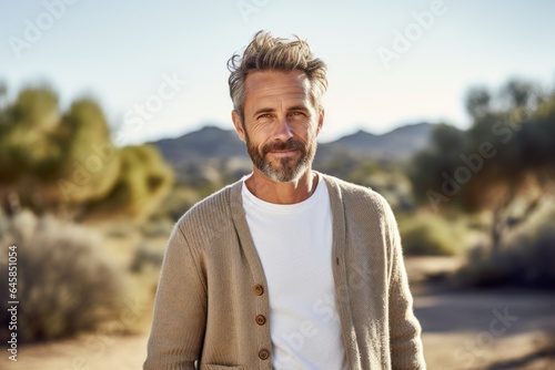 Medium shot portrait photography of a French man in his 40s against a beach background