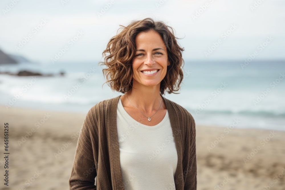 Portrait photography of a Italian woman in her 40s against a beach background Portrait photography of a Italian woman in her 40s against a beach background