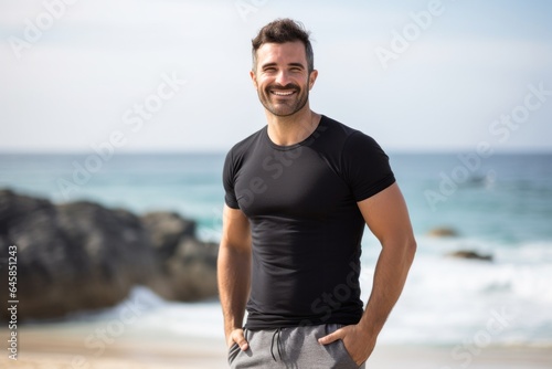 Lifestyle portrait photography of a Italian man in his 30s wearing a pair of leggings or tights against a beach background