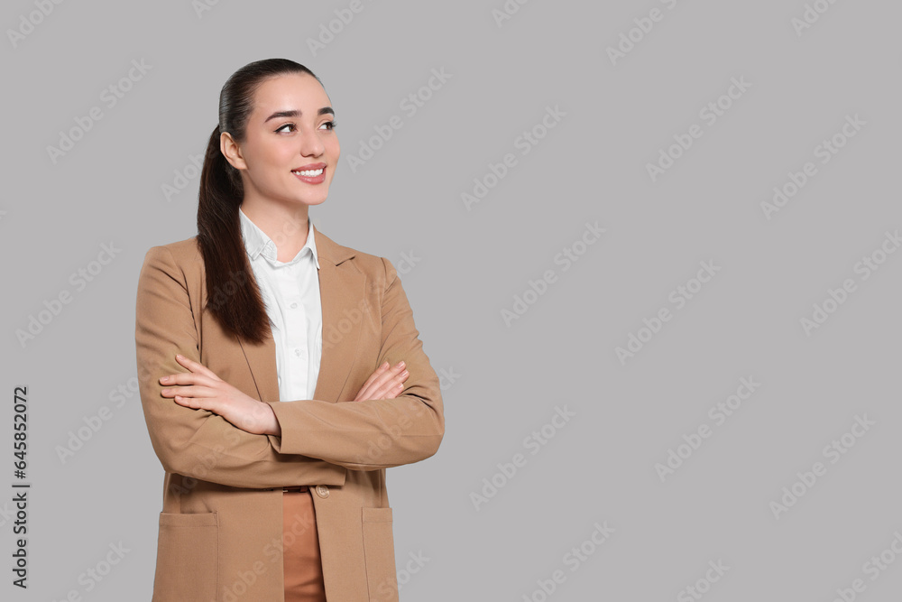 Happy real estate agent on grey background. Space for text Happy real estate agent on grey background. Space for text