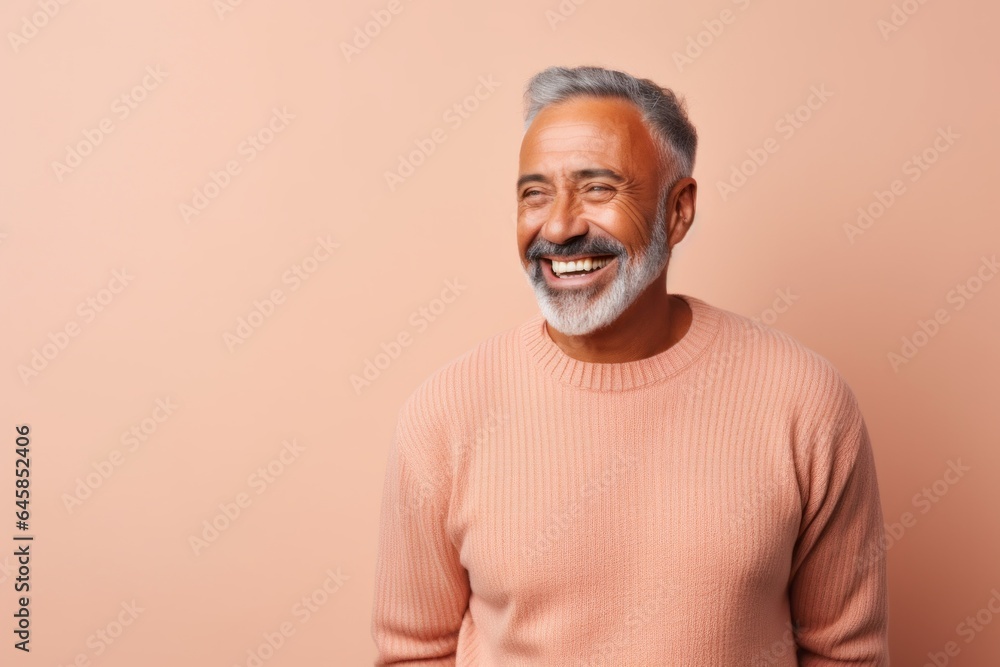 Medium shot portrait photography of a Peruvian man in his 50s wearing a cozy sweater against a pastel or soft colors background