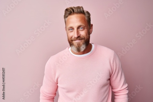 Medium shot portrait photography of a Swedish man in his 40s against a pastel or soft colors background