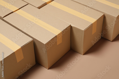 Many cardboard boxes on light brown background