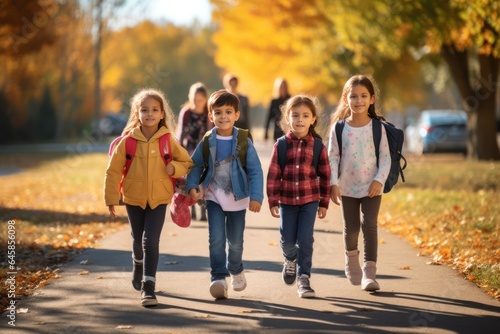 Group of Young  Students, First Graders, Walking Together to School with Backpacks