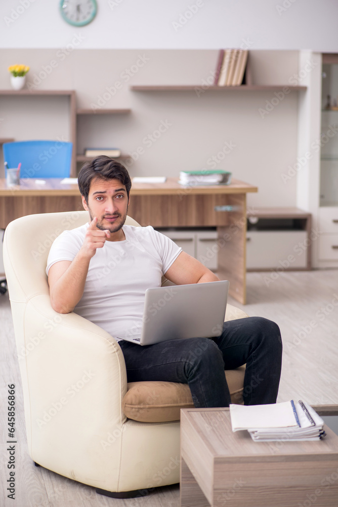 Young male employee working from home during pandemic Young male employee working from home during pandemic