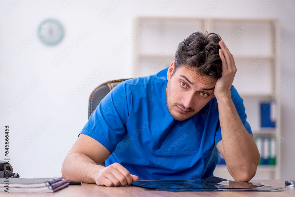 Young male doctor working in the clinic Young male doctor working in the clinic