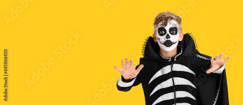 Little boy in Halloween costume on yellow background with space for text © Pixel-Shot