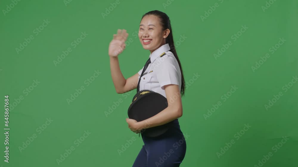 Side View Of Asian Woman Pilot Smiling And Waving Hand While Walking In The Green Screen Background Studio
Side View Of Asian Woman Pilot Smiling And Waving Hand While Walking In The Green Screen Background Studio