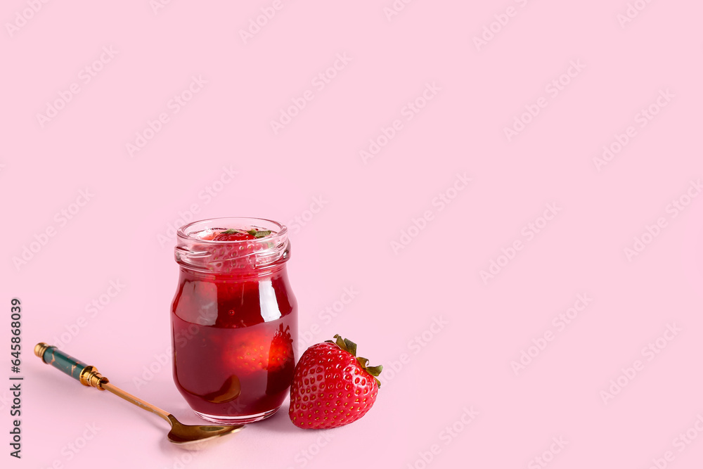 Jar of sweet strawberry jam on pink background