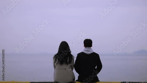 Winter seaside, a couple's back view photo