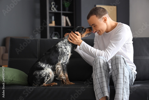 Young man with cute cocker ...