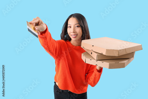 Young Asian woman with cred...