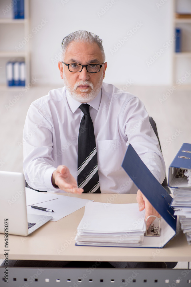 Old male employee and too much work in the office Old male employee and too much work in the office