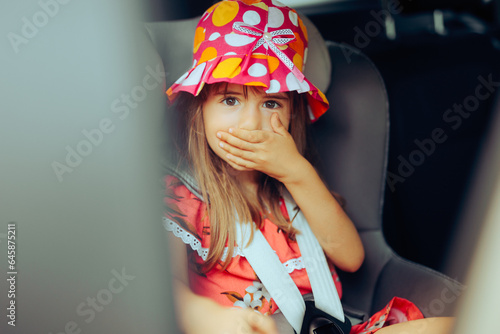 Little Girl Traveling by Car Suffering from Motion Sickness. Child feeling dizzy and nauseated from carsick symptoms 
