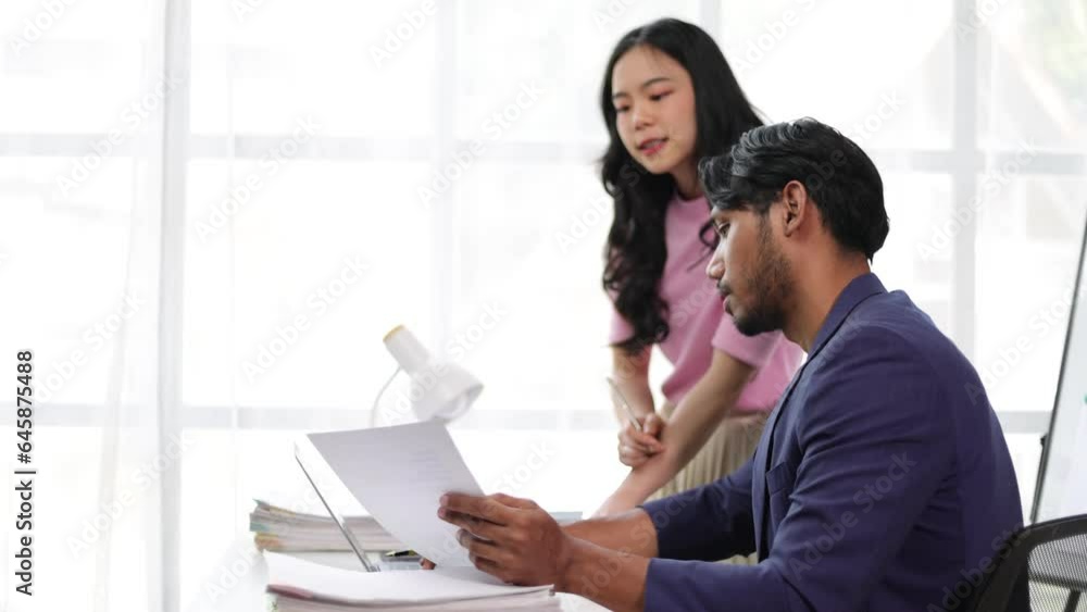 Manager and colleagues discussing work in the office. Manager and colleagues discussing work in the office.