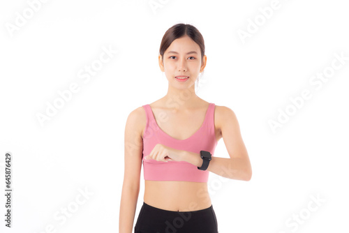 Happy young asian woman looking smartwatch for exercise and aerobics with cardio isolated on white background, female looking smart watch with wrist for pulse while workout with health, sport concept. © N_studio