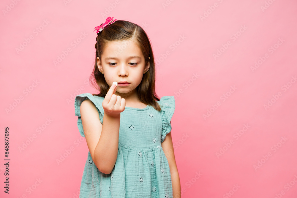Little girl with little money looking sad Little girl with little money looking sad