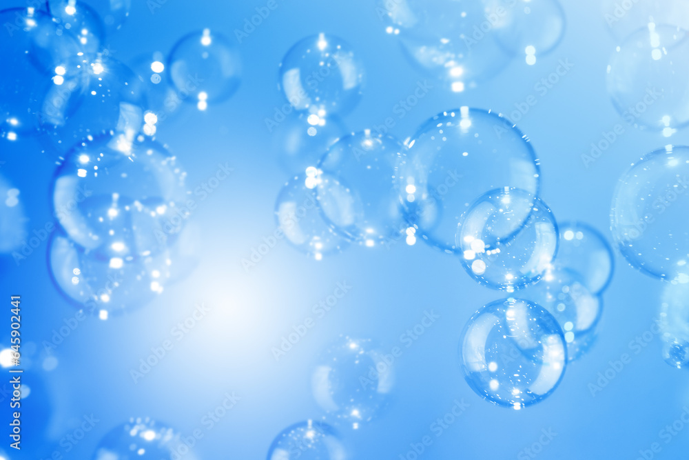 Beautiful Transparent Shiny Blue Soap Bubbles Floating in The Air. Abstract Background, Celebration Festive Backdrop, Refreshing of Soap Suds Bubbles Water. Beautiful Transparent Shiny Blue Soap Bubbles Floating in The Air. Abstract Background, Celebration Festive Backdrop, Refreshing of Soap Suds Bubbles Water.