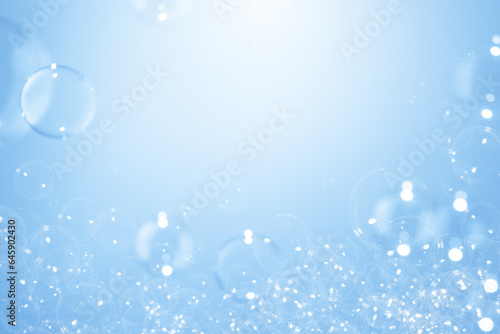 Refreshing of Soap suds Bubbles Water. Beautiful Transparent Blue Soap Bubbles Floating in The Air. Abstract Blurred Background,  Gradient Blue Textured, Celebration Festive Backdrop.