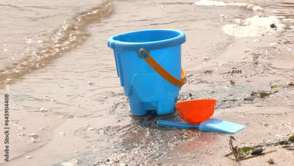 children's toys for playing on the sand. Children's shovel, bucket and molds for the sandbox on the background of the sea. Children's toys in the sand by the water. Bucket, spade. Toys for children
children's toys for playing on the sand. Children's shovel, bucket and molds for the sandbox on the background of the sea. Children's toys in the sand by the water. Bucket, spade. Toys for children