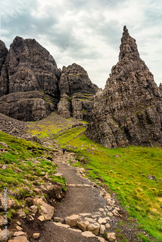 Rock formation of the so-called Old Man of Storr seen from below and with a path to climb to the summit, Scotland, UK.