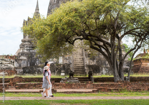 asian child or kid girl travel walking archaeological site or family mother and daughter in pagoda buddha ruins at wat phra si sanphet temple retro or people tourist in ayutthaya old ancient Thailand