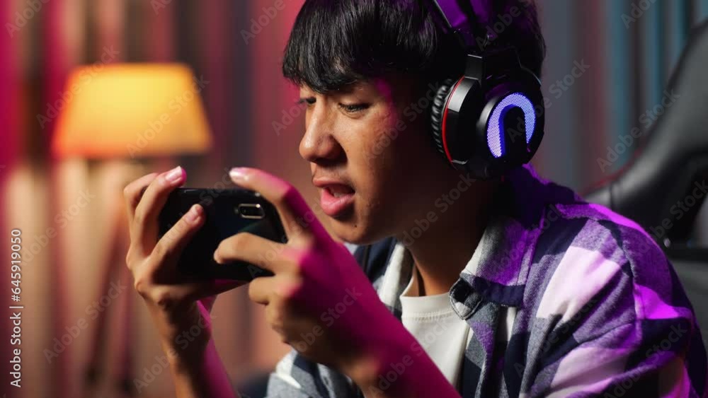 Close Up Of Excited Asian Teen Boy Gamer Celebrates Victory While Playing Video Game On Smartphone
Close Up Of Excited Asian Teen Boy Gamer Celebrates Victory While Playing Video Game On Smartphone