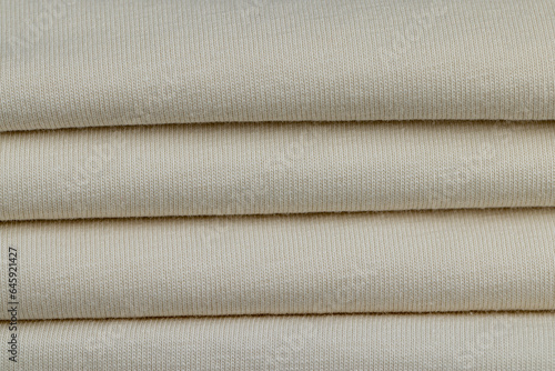 details of a piece of clothing sewn from soft beige cotton fabric