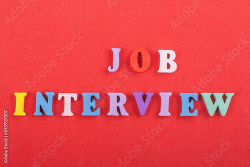 JOP INTERVIEW word on red background composed from colorful abc alphabet block wooden letters, copy space for ad text. Learning english concept.