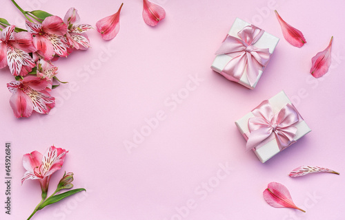 Beautiful Alstroemeria flowers and gift boxes on pink background