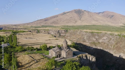 Orbital drone footage of Hovhannavank monastery, Kasakh canyon and Mount Ara on sunny summer day. Ohanavan village, Armenia. photo