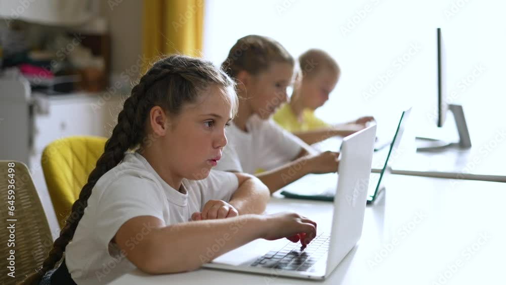 Group of children at school online learning. Teamwork of children with laptop online learning as a team. Children learn together at school to work as team with laptop.Team learning at school in lesson Group of children at school online learning. Teamwork of children with laptop online learning as a team. Children learn together at school to work as team with laptop.Team learning at school in lesson