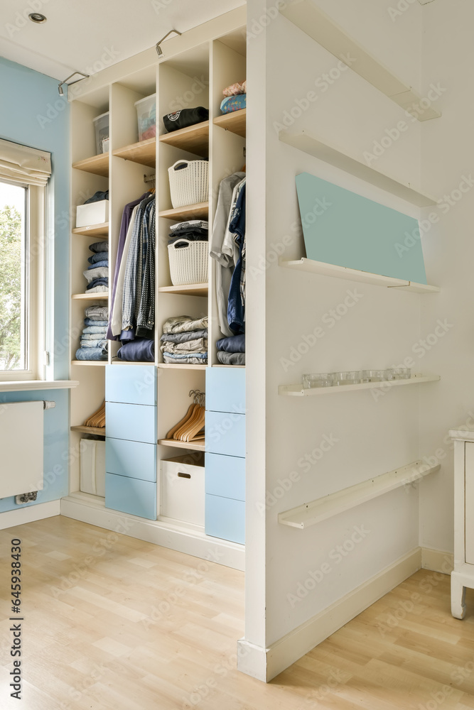 a walk - in closet with blue cabinets and white shelvings on the floor next to an open door