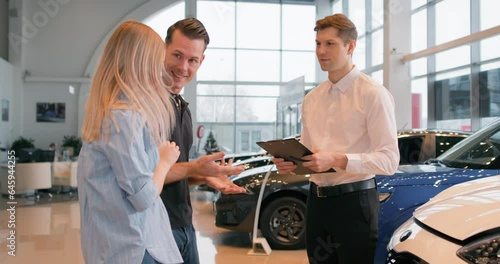 happy Caucasian young family has bought new car on Black friday Man shaking hands with trader. Success, business. couple celebrating bargain, clapping hands applauding Slow motion, successful shopping