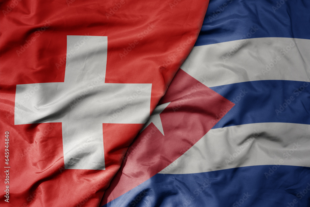 big waving national colorful flag of switzerland and national flag of cuba . big waving national colorful flag of switzerland and national flag of cuba .