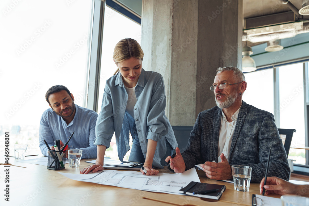Team of business investors is discussing a new project in modern office. Concept of financing Team of business investors is discussing a new project in modern office. Concept of financing