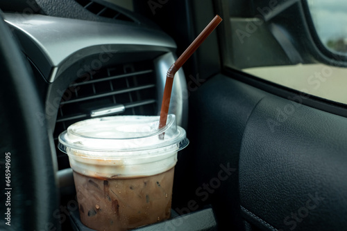 Ice coffee with plastic cup in the car cup holder. coffee on the road while driving.espresso,latte,cappuccino,arabica,ice cocoa