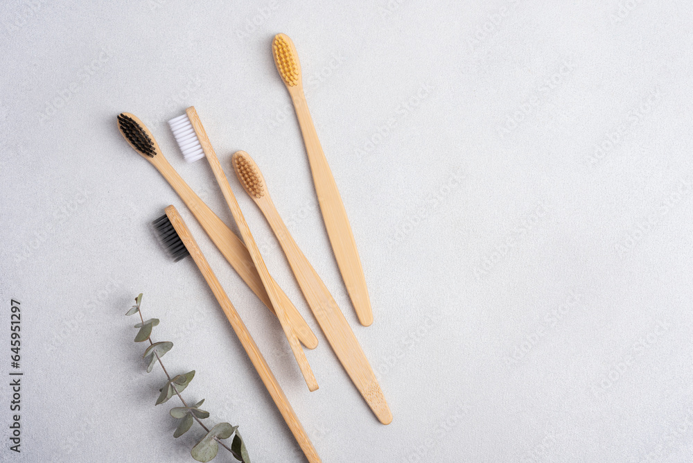 Eco-friendly bamboo toothbrushes on grey background Eco-friendly bamboo toothbrushes on grey background
