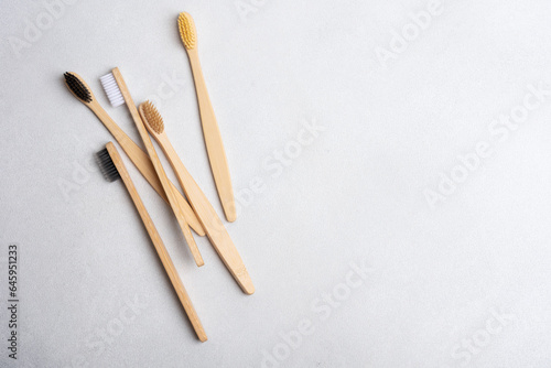 Eco-friendly bamboo toothbrushes on grey background