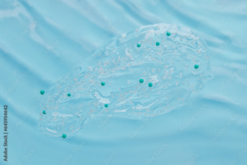 clear wash gel with granules on the background of blue water clear wash gel with granules on the background of blue water