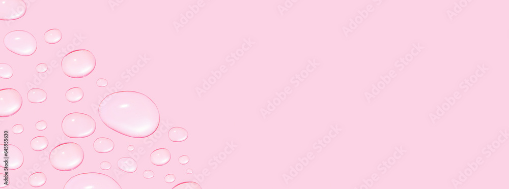 Drops of transparent gel or water in different sizes. On a pink background.