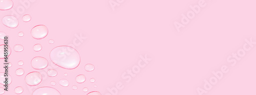 Drops of transparent gel or water in different sizes. On a pink background.