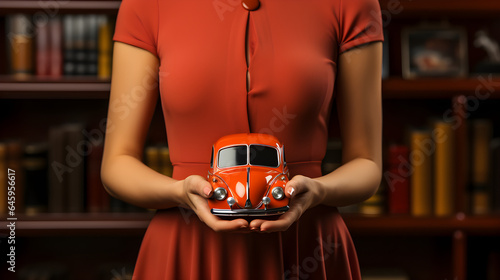 The car concept is symbolized by female hands protecting a car. Car Insurance Concept