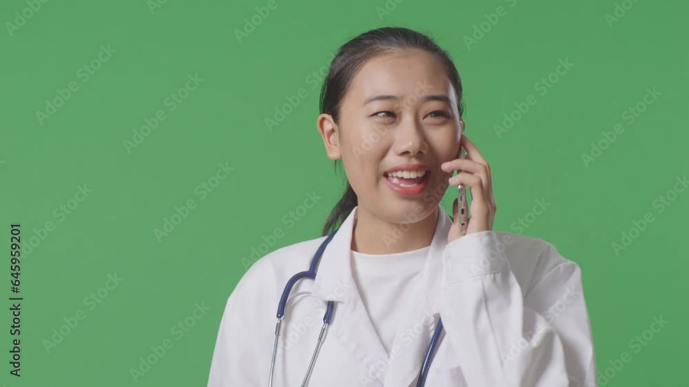 Close Up Of Asian Female Doctor With Stethoscope Talking On Smartphone While Walking On Green Screen Background In The Hospital
Close Up Of Asian Female Doctor With Stethoscope Talking On Smartphone While Walking On Green Screen Background In The Hospital