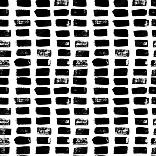 Seamless pattern with short hand drawn strokes . Vector with vertical black brush strokes in grunge style. Texture in hipster style with linees. Abstract monochrome background .